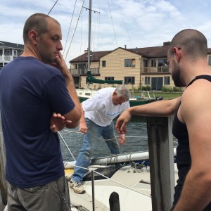 Contemplation and consultation between the mates.  "Should we suggest a better way?" they whisper quietly to themselves. The captain is eager to begin and jumps aboard.